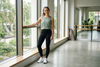 Sports leggings styled with an athletic top and trainers in a bright workout studio