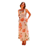 A model wearing a floral patterned, long, backless, and strapless midi dress, suitable for office wear.