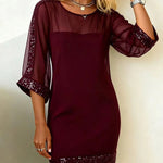 Burgundy dress with sheer sleeves and hem on a plain background