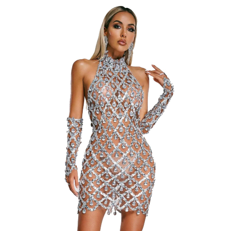 Woman wearing a sparkling silver dress with long gloves on a white background