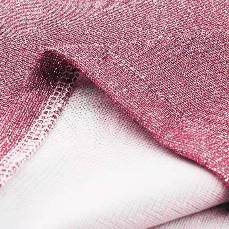 Close-up of pink glittery fabric on a white background