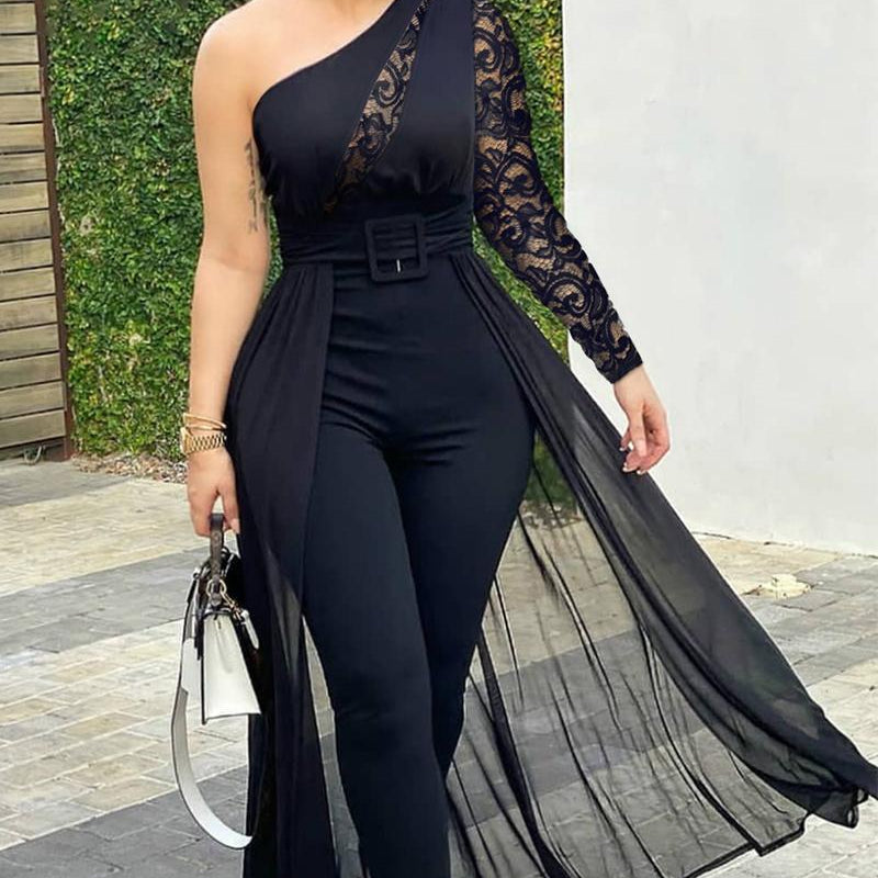 Woman wearing a black one-shoulder jumpsuit with lace detailing outdoors.