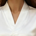Close-up of a white blouse on a mannequin with a blurred background