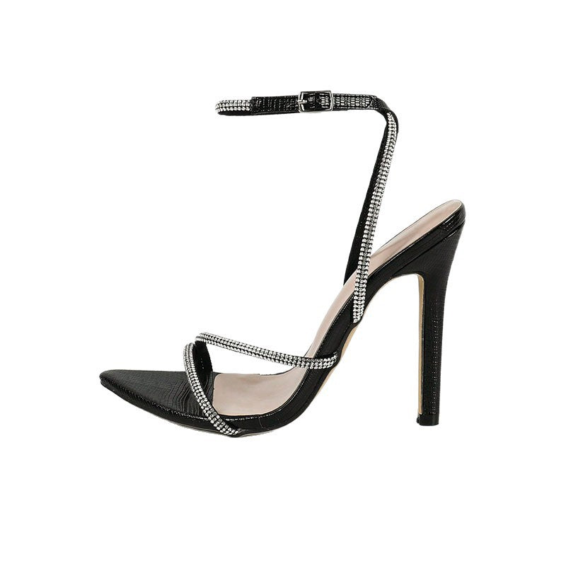 Black high-heeled sandal with thin straps on a white background
