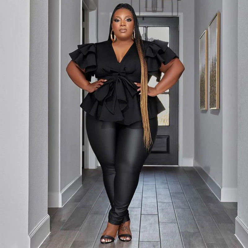 Woman in a black outfit standing in a hallway