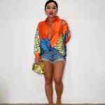 A loose-fit, long-sleeve shirt with a striking animal print pattern.