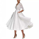 White dress with lace top and satin skirt on a white background