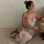 Text: A strapless, bodycon midi dress with a floral print, shown in a purple color.