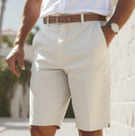 Person wearing light-colored shorts with a blurred background