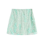 A light green ultra-short A-line skirt featuring 3D embroidery, tulle, and sequin flower details.