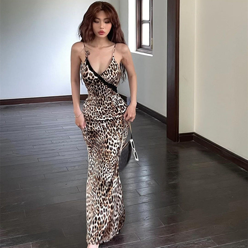 A full-length shot of a person wearing a fitted, strapless midi dress with a retro leopard print pattern. The dress features a high waist and a backless design.