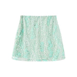 A light green ultra-short A-line skirt featuring 3D embroidery, tulle, and sequin flower details.