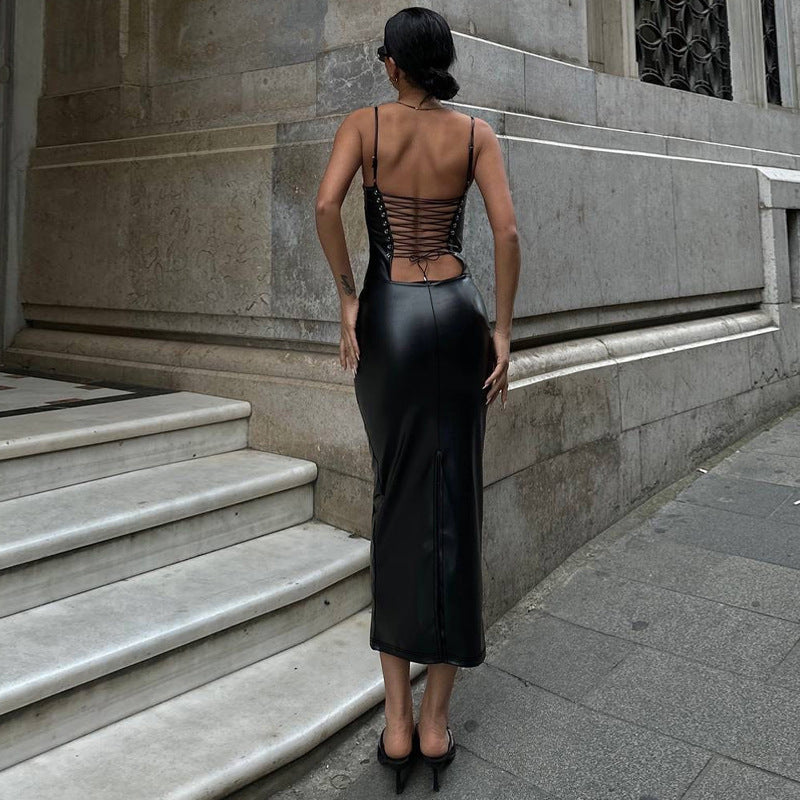 This backless suspender dress features a daring hip slit and a zip-tied waist bag for an edgy, bold look.
