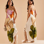 Woman wearing a slim-fit floral midi dress with asymmetric neckline and sleeveless design