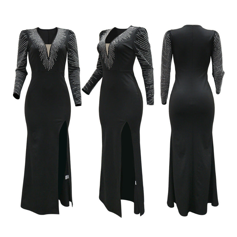 A model wearing a solid black deep V-neck high slit maxi dress with a halter neck.