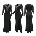 A model wearing a solid black deep V-neck high slit maxi dress with a halter neck.