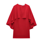 This short dress features a bold, loose cape design that makes a striking statement with effortless style.