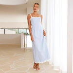 A light blue, slimming midi dress with a one-shoulder neckline and delicate lace straps, shown on a model.