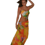 A backless strapless beach dress with a gradient floral pattern.