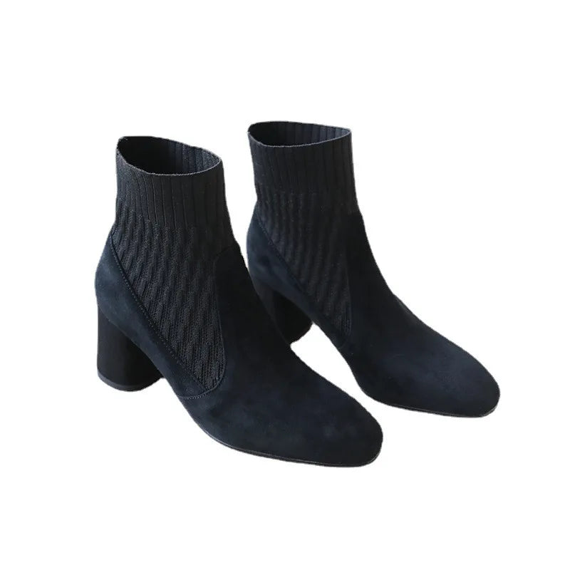 A pair of black casual lightweight ankle heel boots with a thick heel, against a neutral background