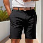 Person wearing black shorts with a brown belt outdoors