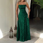 Woman wearing a green evening gown in an indoor setting with lanterns and plants.
