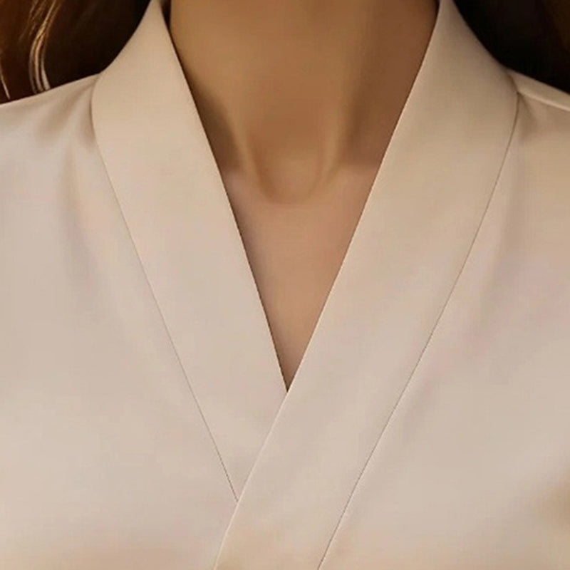 Close-up of a beige blouse on a mannequin