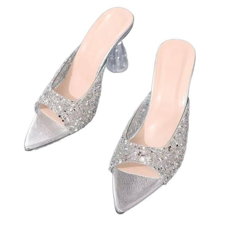 Pair of silver glitter high heels on a white background
