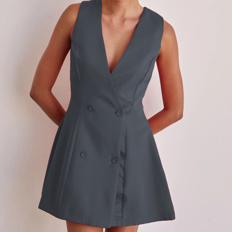 A model wearing a solid color sleeveless short V-neck dress.