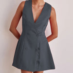 A model wearing a solid color sleeveless short V-neck dress.