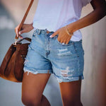 A pair of light blue, mid-waist denim shorts with a straight-leg, wide-leg fit. The shorts feature ripped and distressed details, showcasing a casual street-style look.
