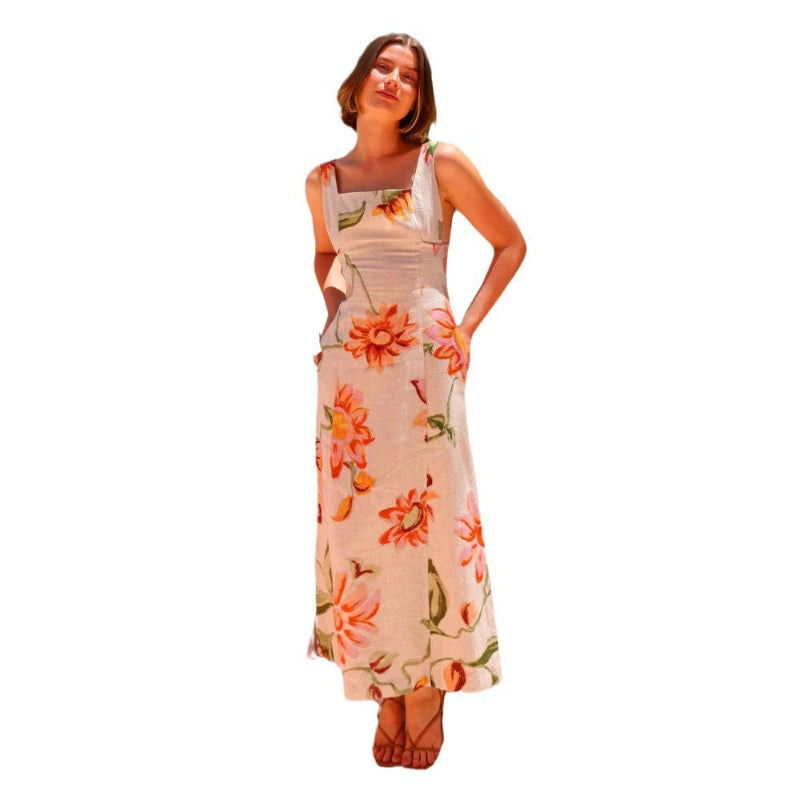 A model wearing a floral patterned, long, backless, and strapless midi dress, suitable for office wear.
