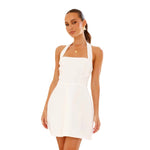 A model wearing a solid color short halter dress with a one-shoulder design.