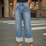 A pair of light blue, faded, straight leg high-waisted jeans for women.