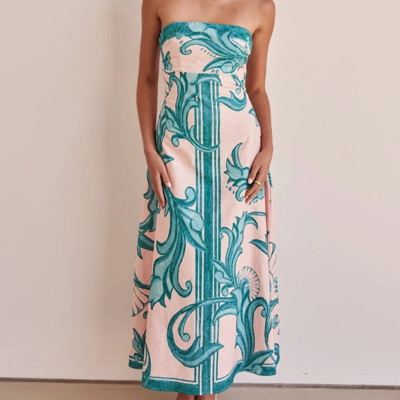 A model wearing a slim-fit, strapless, printed midi dress with a one-shoulder collar, suitable for casual wear.