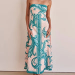 A model wearing a slim-fit, strapless, printed midi dress with a one-shoulder collar, suitable for casual wear.