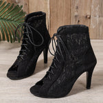 A pair of black, ultra-high, slim high-heeled mesh sandal boots with a fish-mouth toe.