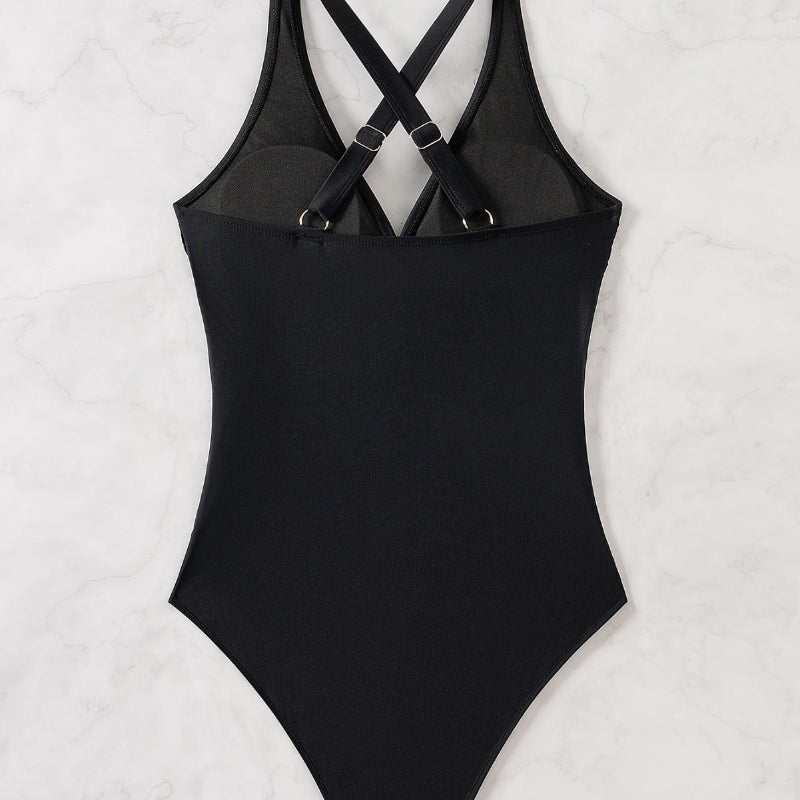 This high-waist swimsuit features a daring crossed design that sculpts and flatters your figure with slimming appeal.