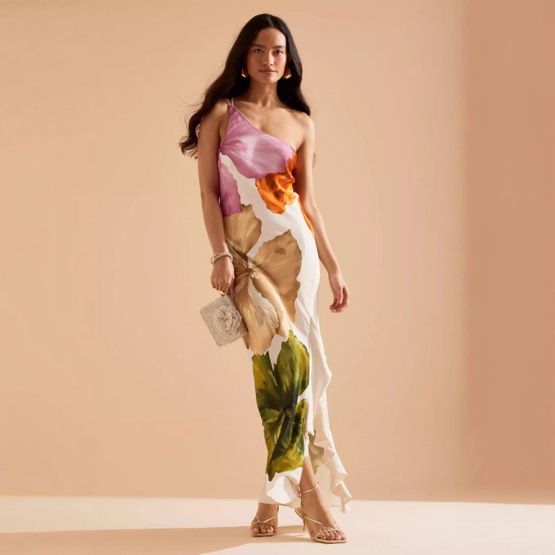 Woman wearing a slim-fit floral midi dress with asymmetric neckline and sleeveless design