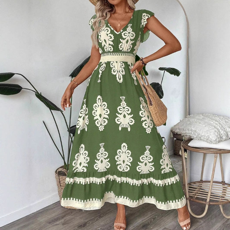 A stylish model wearing an elegant floral V-neck midi dress in a dark blue color. The dress has a waist-cinched design and a beautiful positional flower pattern, perfect for an elegant commuting style.