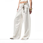 A pair of white, retro-style curved knife jeans with reverse embroidered detailing. The unique seam and leg shape are visible, highlighting the modern and edgy design.