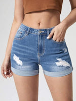 A pair of light blue, high-waisted denim shorts with distressed holes and a cuffed hem. The shorts have a skinny fit and are displayed on a flat surface.