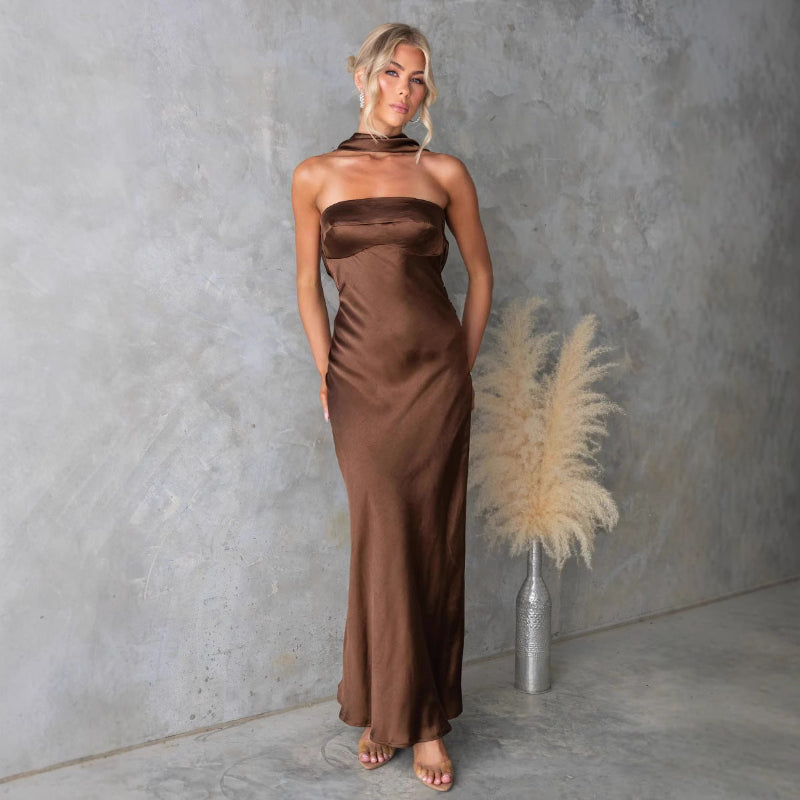 Model wears sleeveless blue hanging neck midi dress with elegant flow and high-fashion appeal