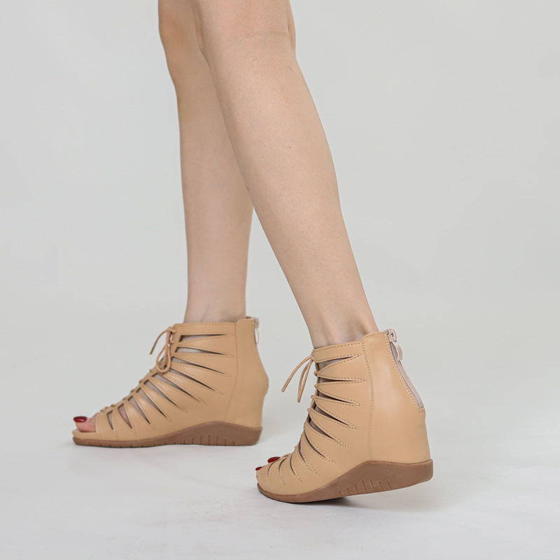 A pair of black high-top Roman sandals with a fish mouth toe style and lace-up closure.