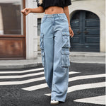 A pair of light blue, wide-leg, high-waist jeans with multiple pockets and pleated details. The jeans are displayed flat, showing the loose, straight-leg cut and zipper style.