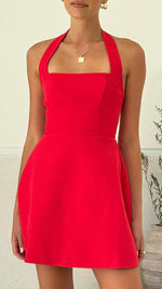 A model wearing a solid color short halter dress with a one-shoulder design.