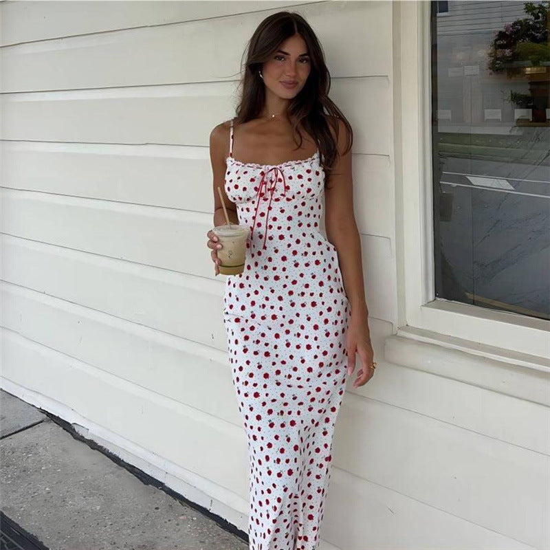 A pink floral print one-shoulder dress with a lace hem, displayed on a mannequin to showcase its long, fitted shape and sweet style.