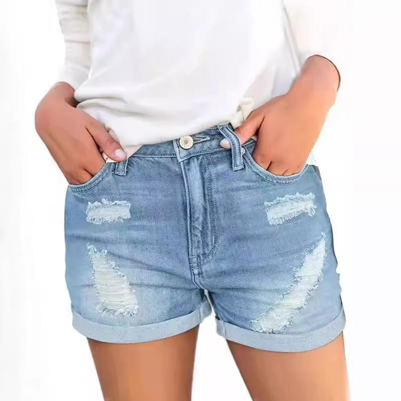 A pair of black, distressed denim shorts with a cuffed hem. The shorts have a loose fit and a mid-rise waist, showcasing a casual yet stylish look.