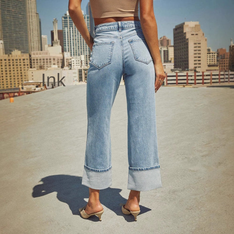 A pair of light blue, faded, straight leg high-waisted jeans for women.