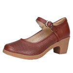 A pair of hollow sandals with a buckle closure, round toe, and low heel, showcasing the casual style and comfortable design.